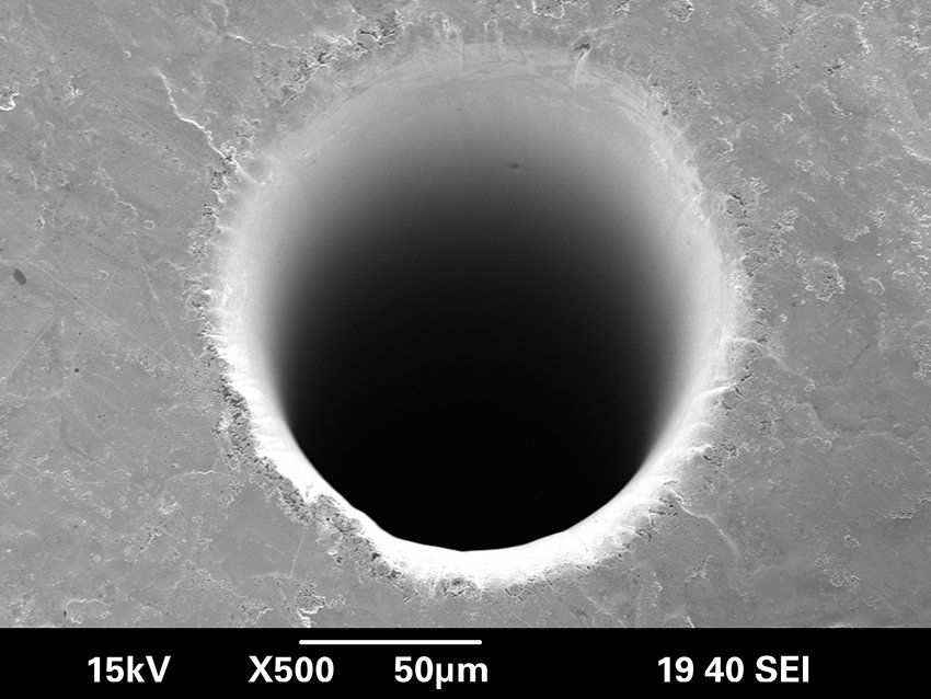 Microhole drilled in gold-platinum with an ultrafast laser, entrance side