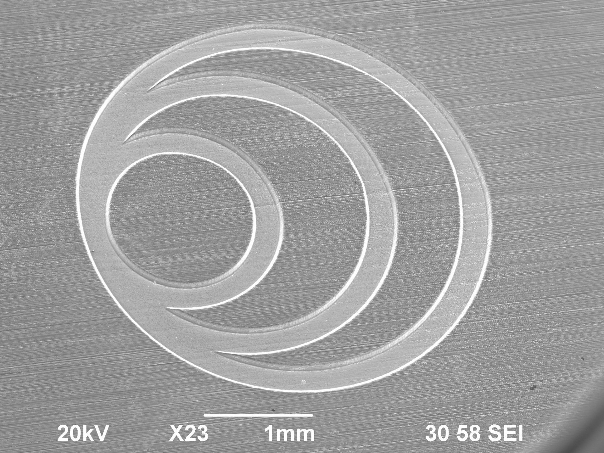 Micro engraving of the LightPulse logo on a steel surface