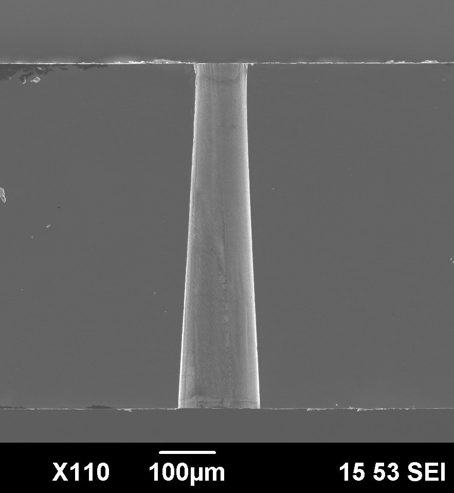Cross-section of a negative-conical hole drilled with an ultrashort pulse laser