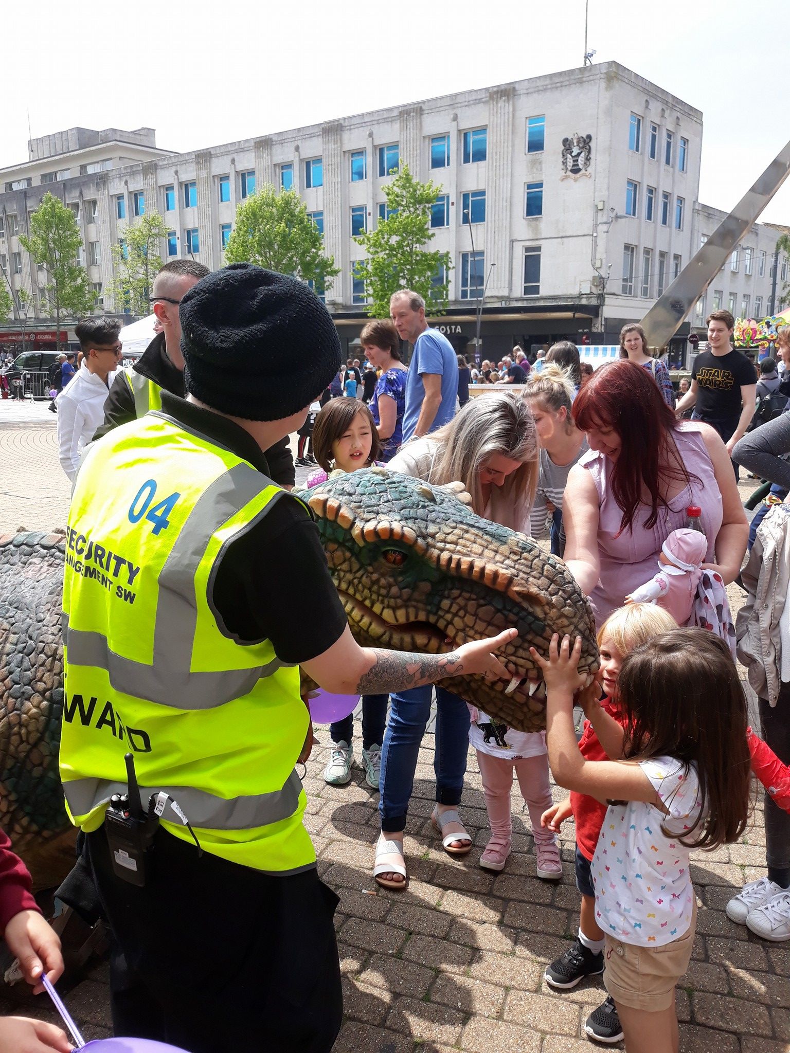 Science Dome UK at outdoor festival outside a shopping centre with dinosaur performance for children.
