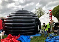 Science Dome UK employees setting up an outdoor planetarium for a festival in the UK