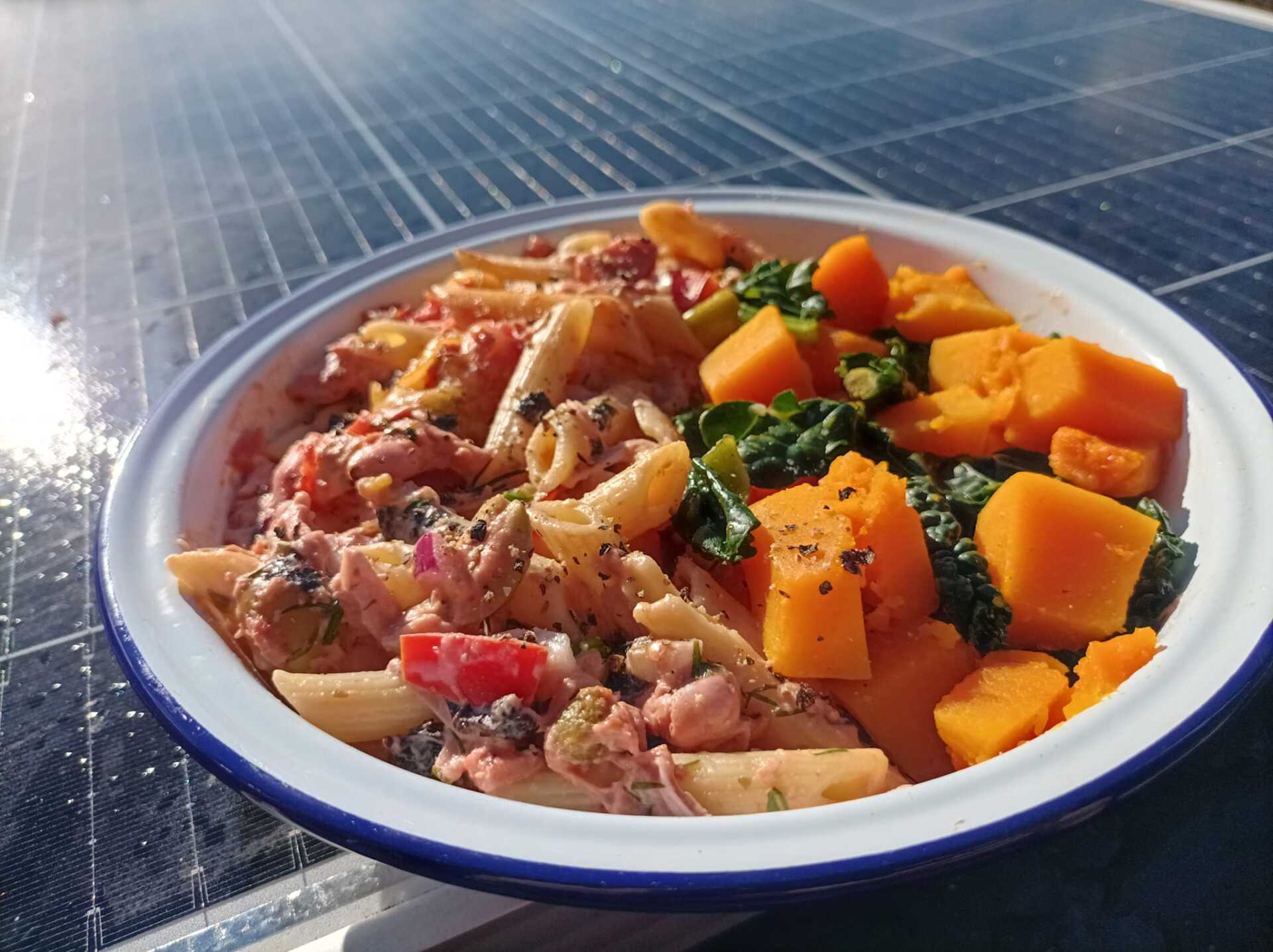 Jackfruit pasta bake in a bowl with kale and pumpkin on the side