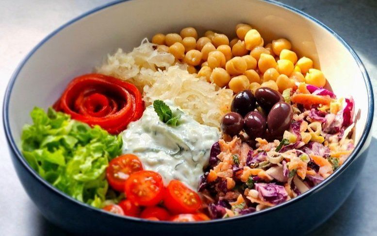 Rainbow Salad Bowl with slaw, chickpeas, minty sauce, and a red pepper rose