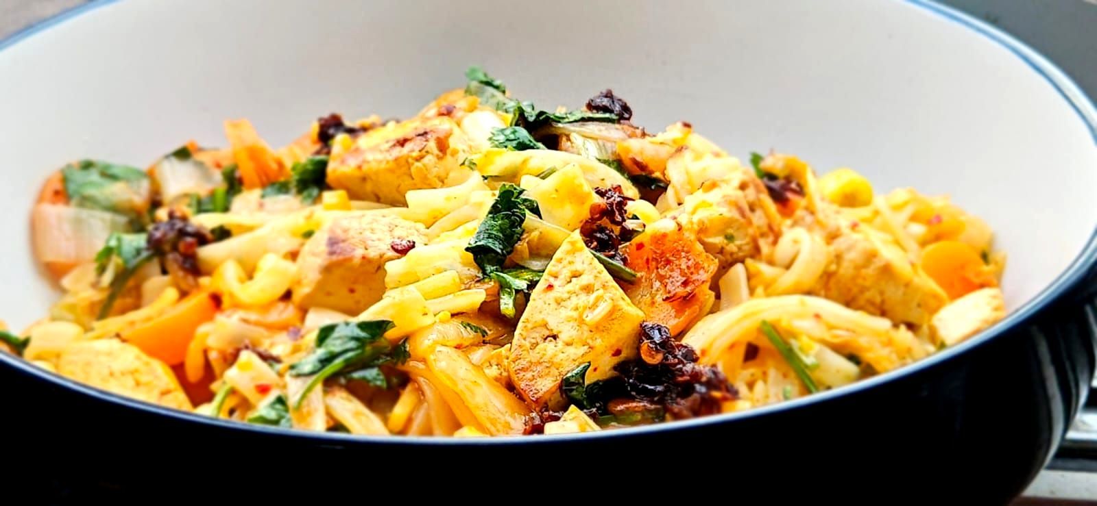 Kimchi noodle stir fry with tofu on a large bowl