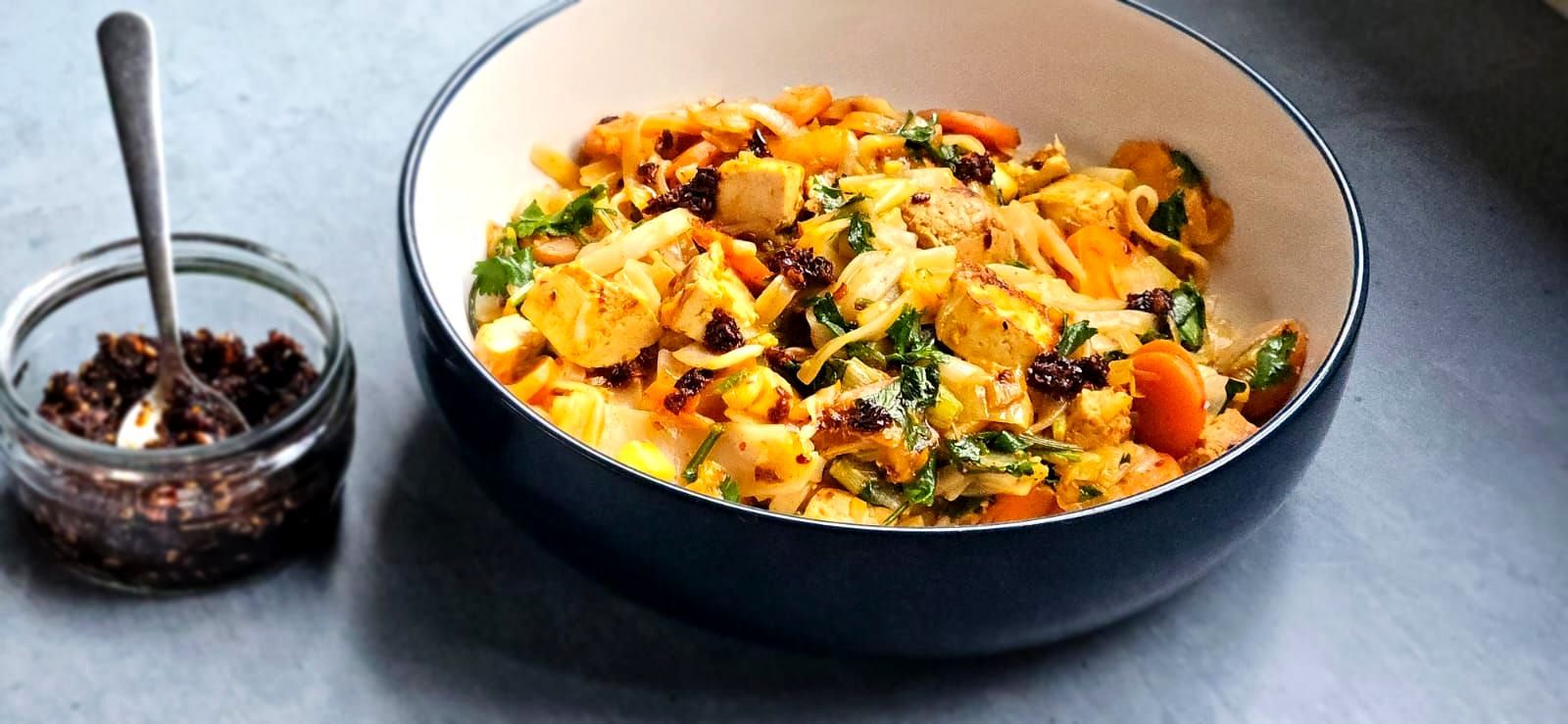 Kimchi noodle stir fry with tofu on a large bowl