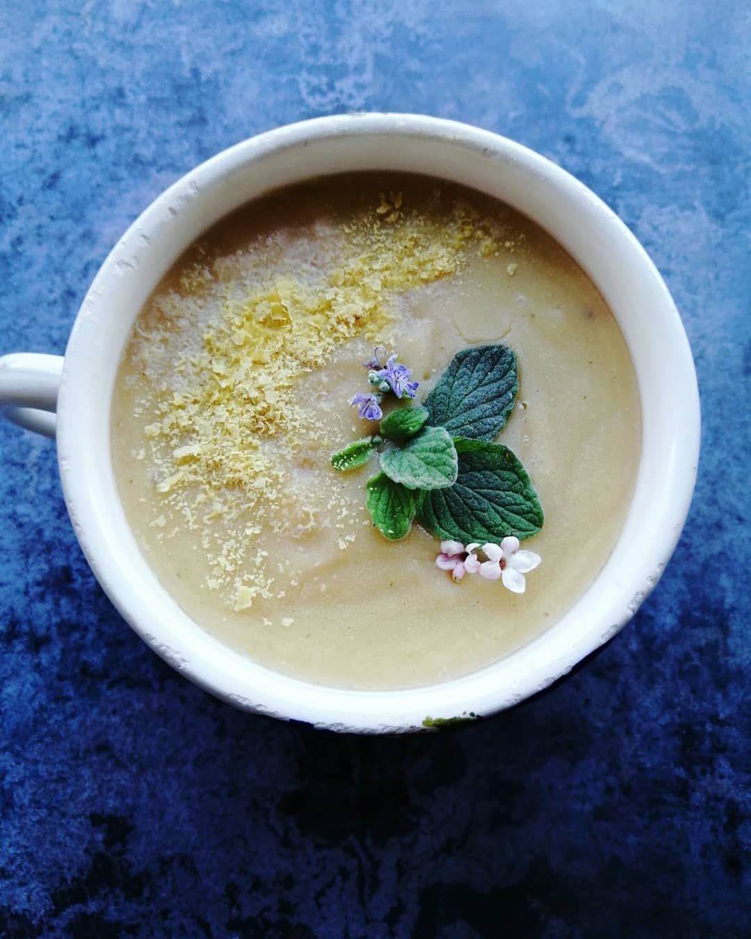 creamy lentil soup with oregano and nutritional yeast garnish