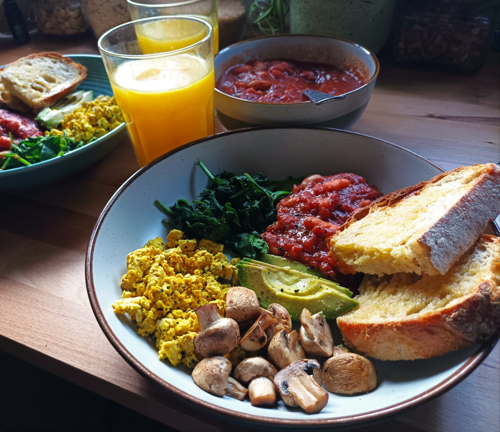 A Cooked Breakfast with beans, tofu scramble, toast, mushrooms, avocado and spinach