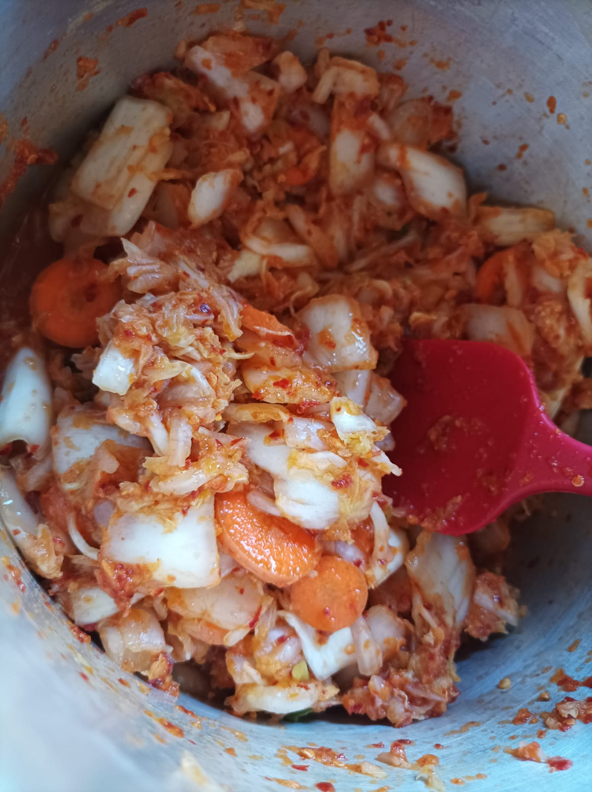 Kimchi vegetables in a saucepan mixed with sauce