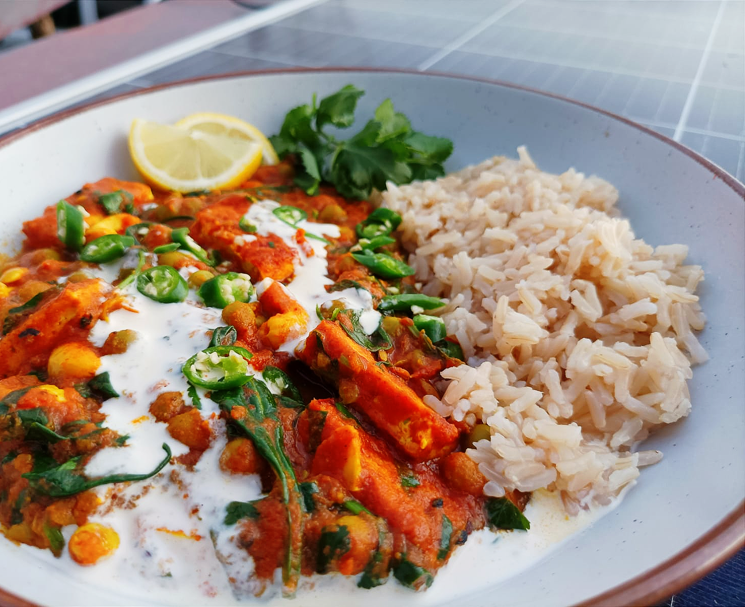 tofu tikka curry served with brown rice and a tomato sauce