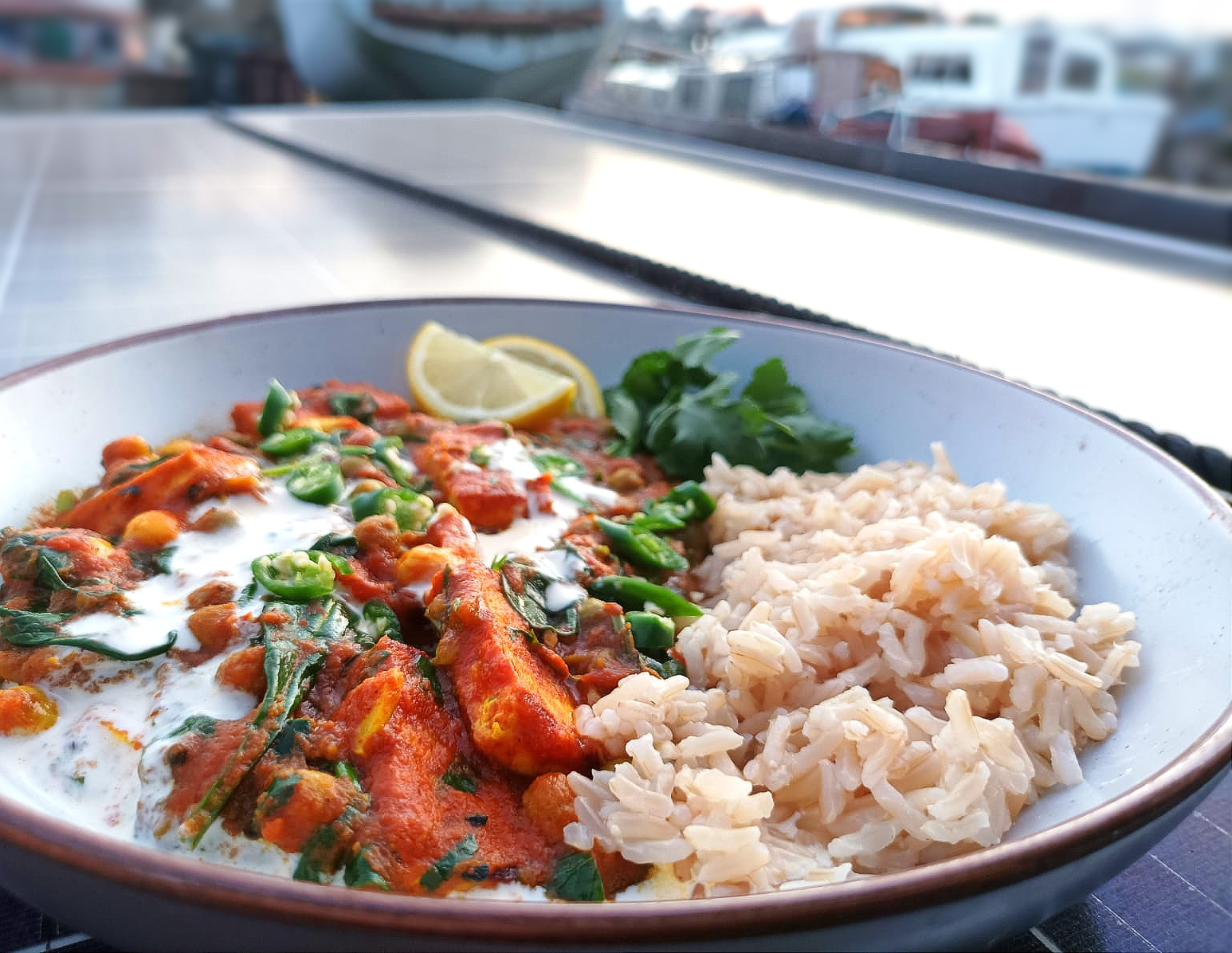 tofu tikka curry served with brown rice and a tomato sauce