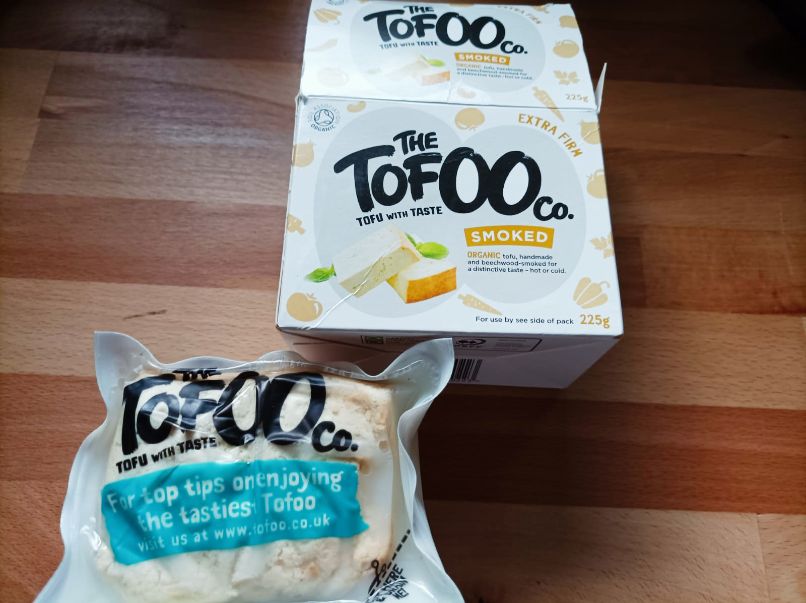 packet of smoked tofu alongside a block of tofu