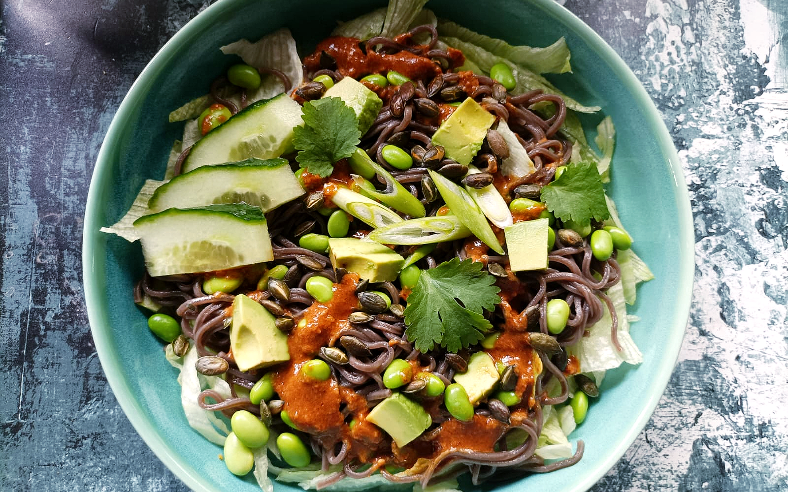 a bowl of noodle salad with a dressing
