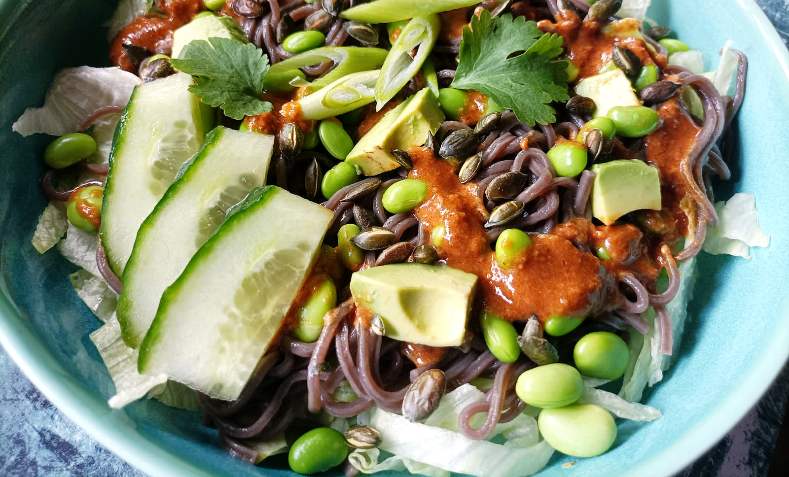 a bowl of noodle salad with a dressing