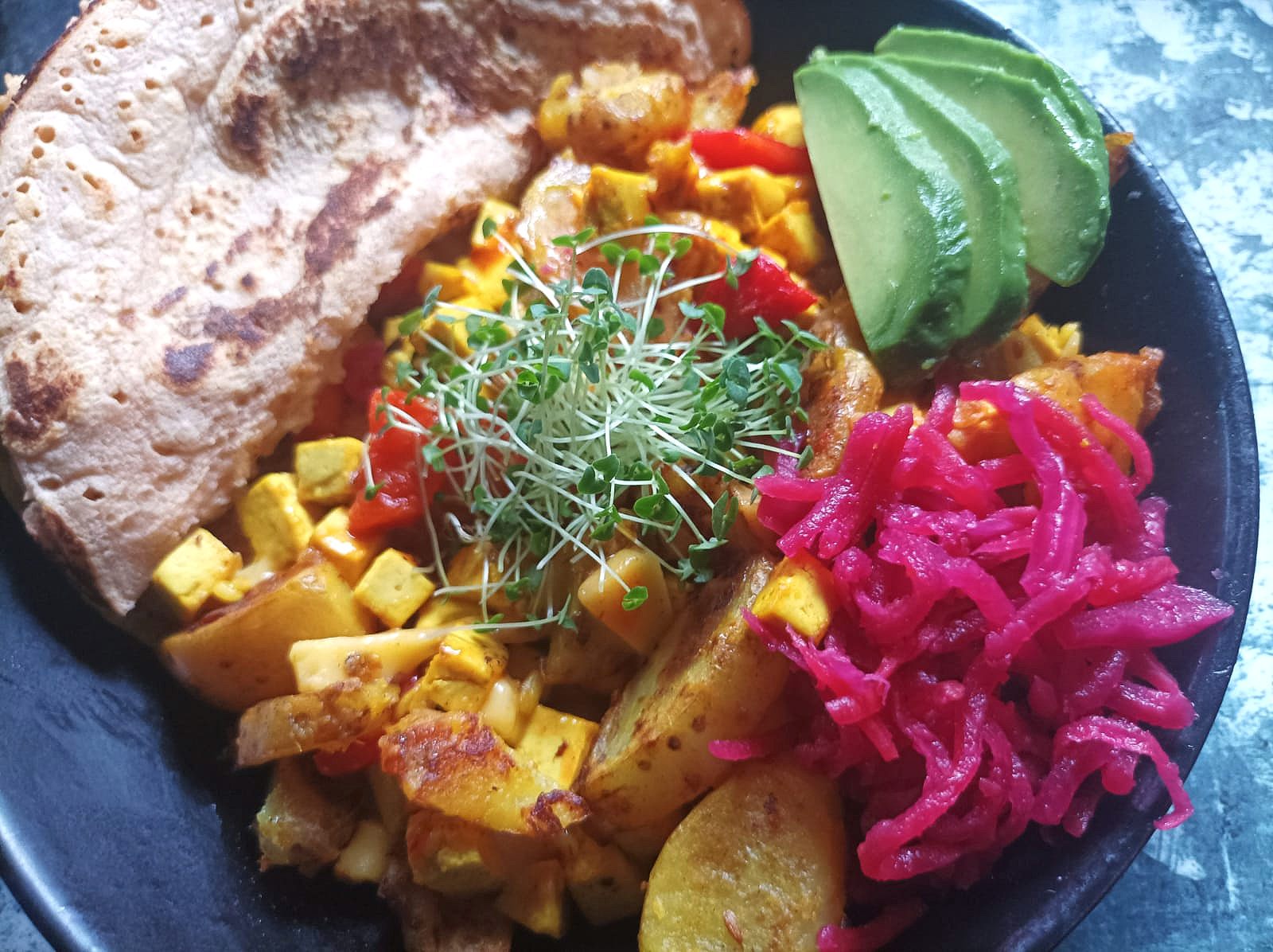 tofu hash with pink kimchi, avocado, and wrap