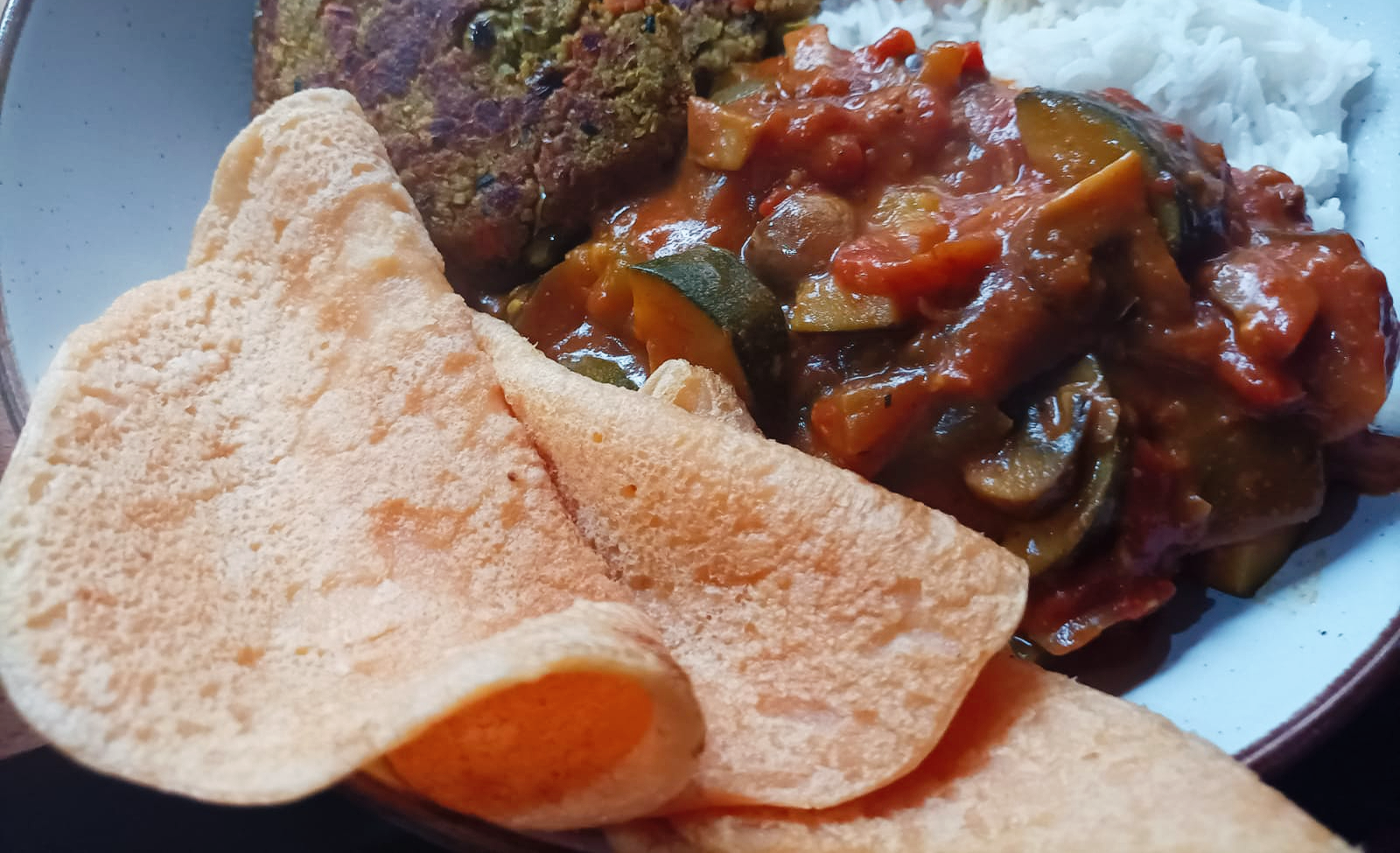 lentil wraps served with veggie burgers, vegetable curry and rice