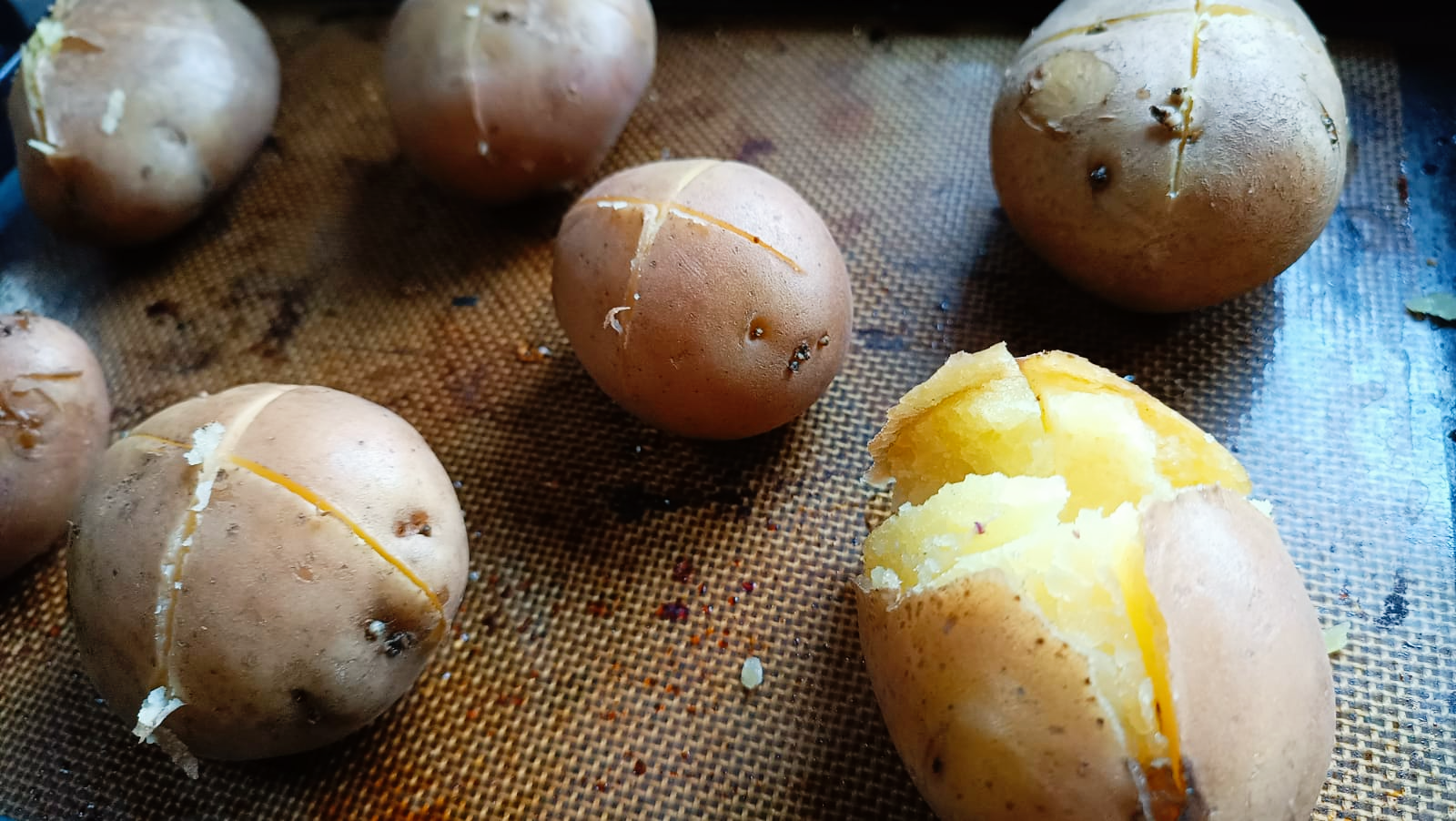 boiled potatoes on a baking sheet
