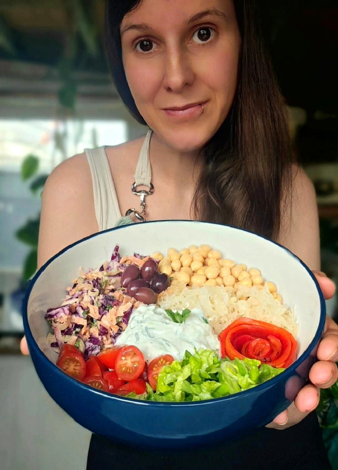 rose with a buddha bowl full of veggies with chickpeas, slaw and tzatziki