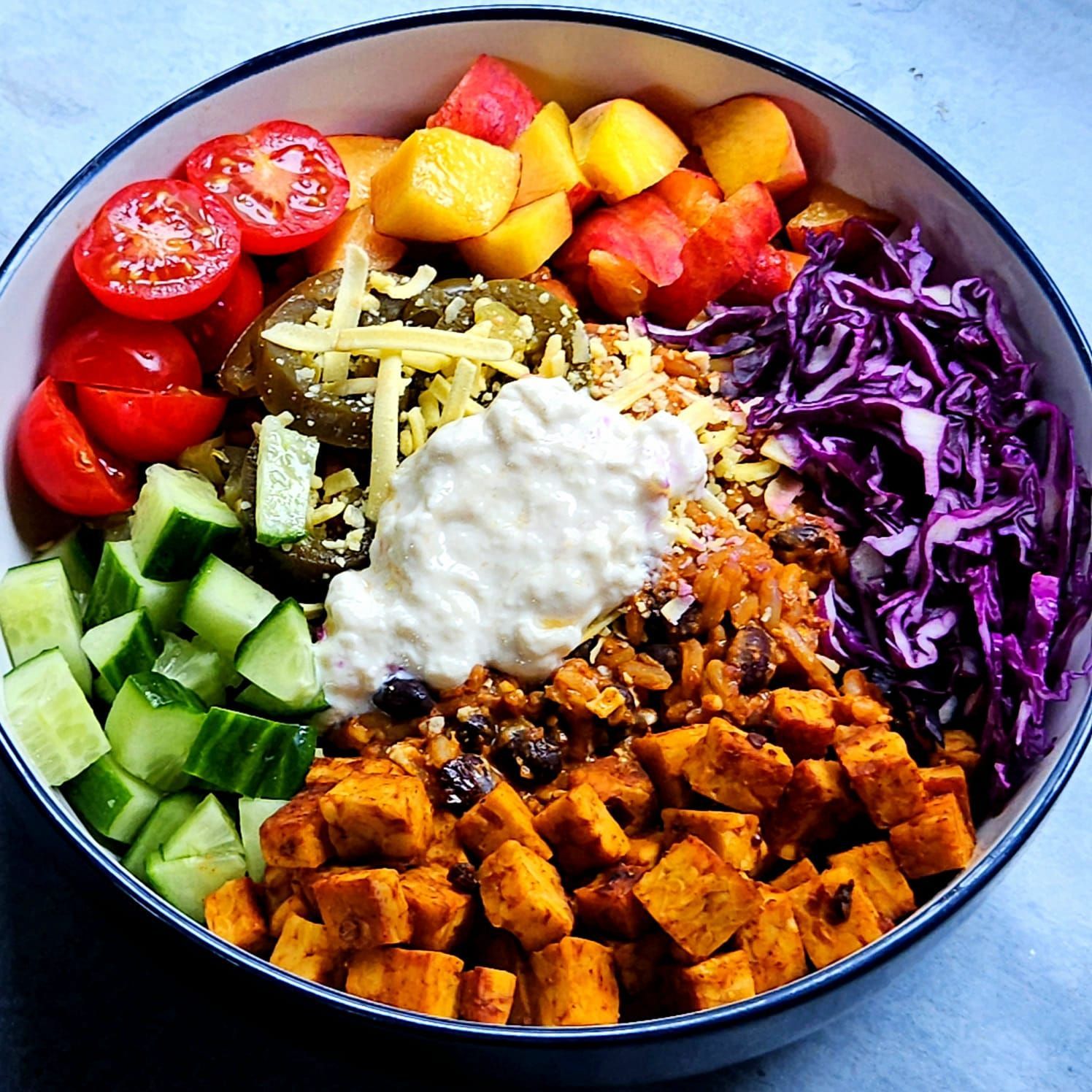 chipotle tempeh mexican bowl with jalapenos, vegan cheese, red cabbage, and yogurt. image 1