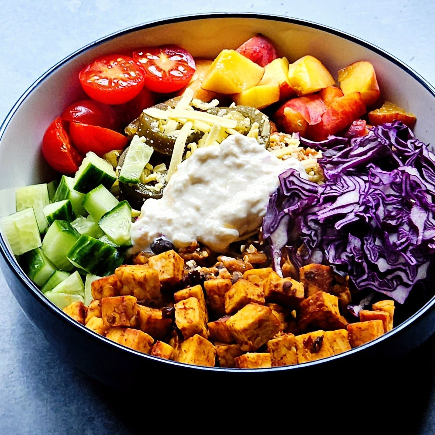 chipotle tempeh mexican bowl with jalapenos, vegan cheese, red cabbage, and yogurt. image 2
