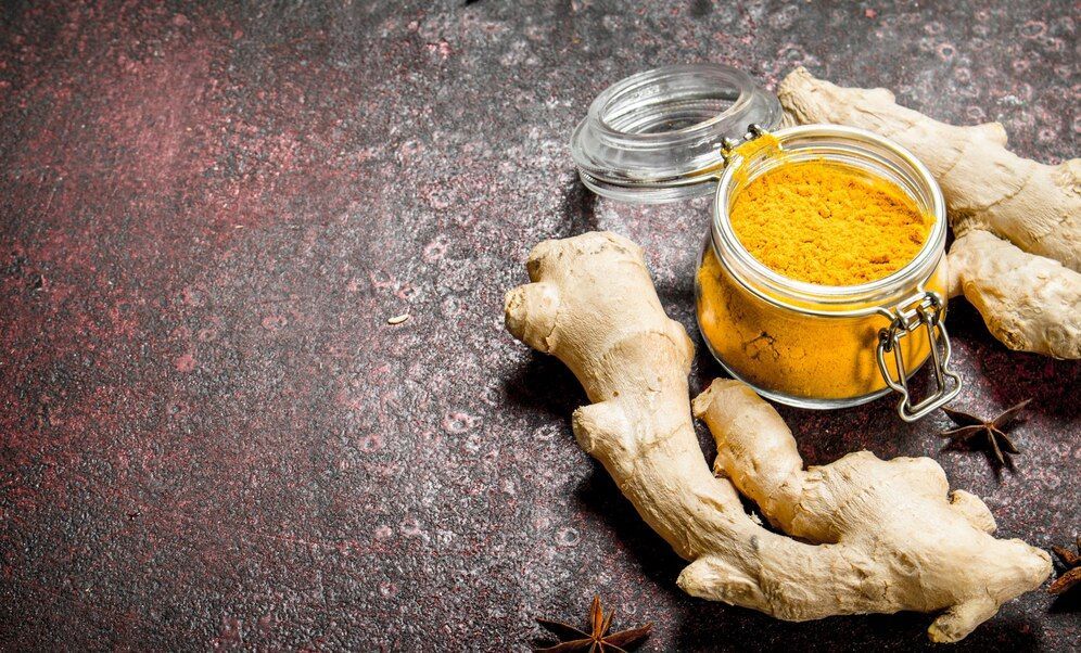 turmeric in a jar with root ginger