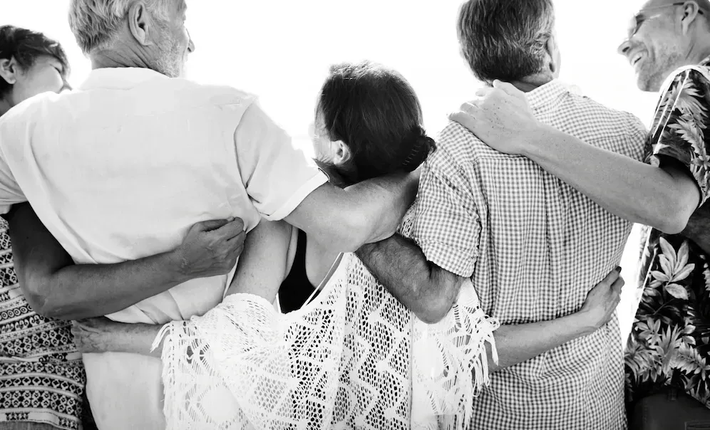 a group of senior adults on a beach
