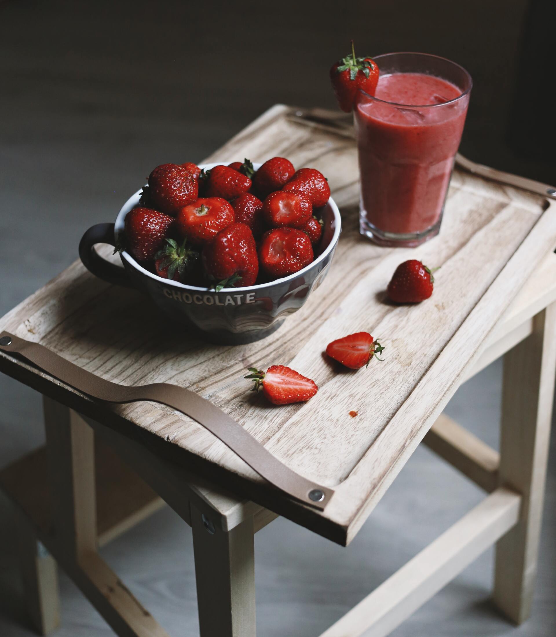 strawberry smoothie with strawberrys in a bowl on a table