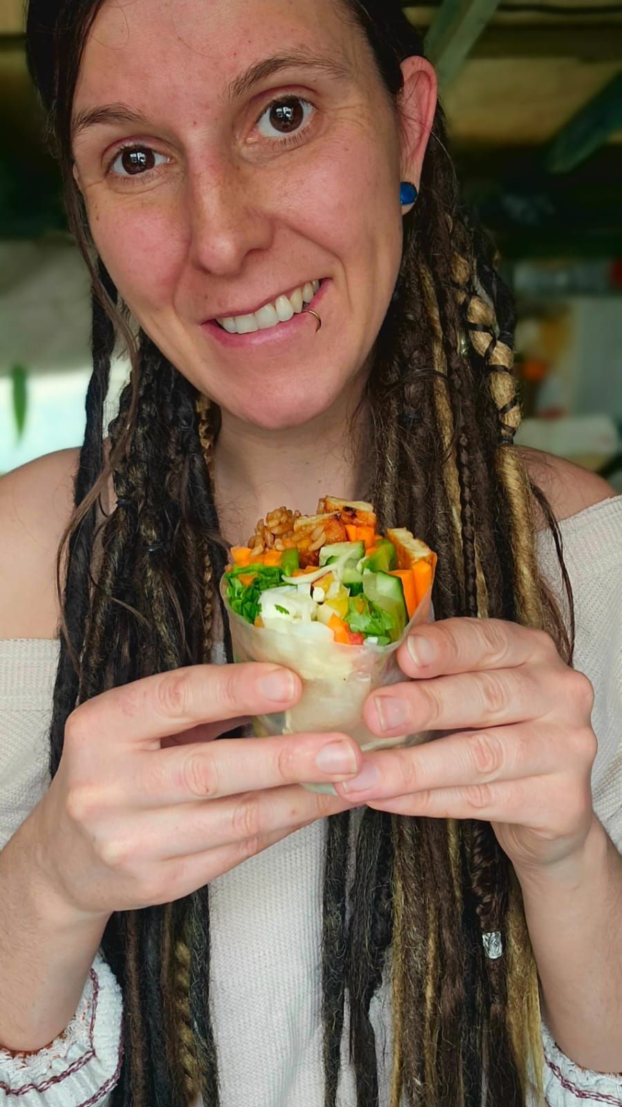 Rose wyles holding her korean bbq tempeh summer rolls
