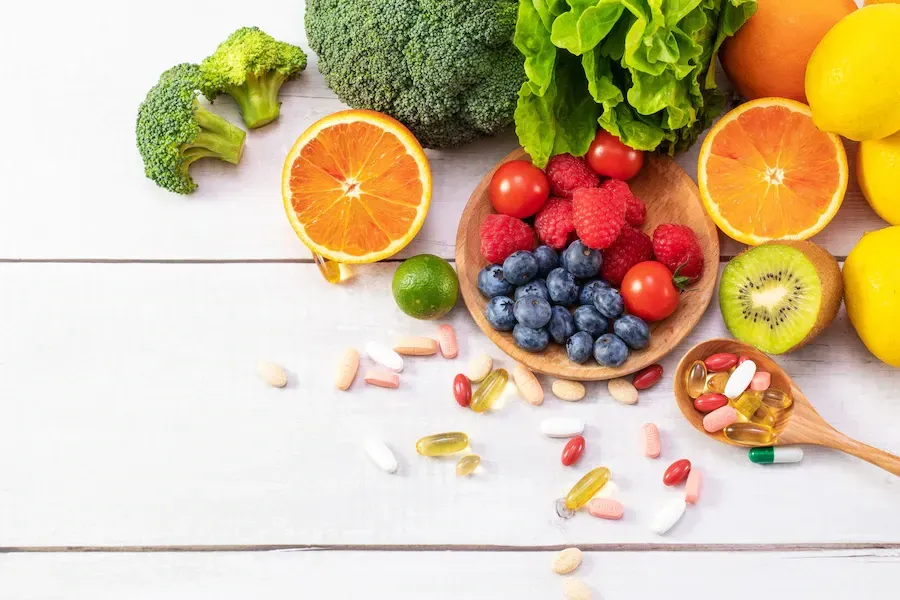 fruit and vegetables on a table with supplements