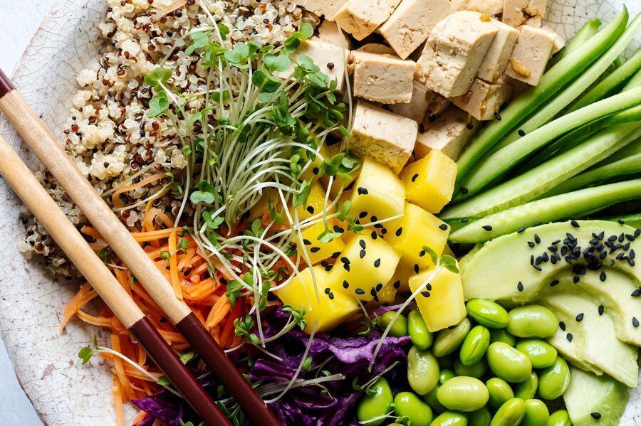 buddha bowl with fresh veg, quinoa, tofu, and greens