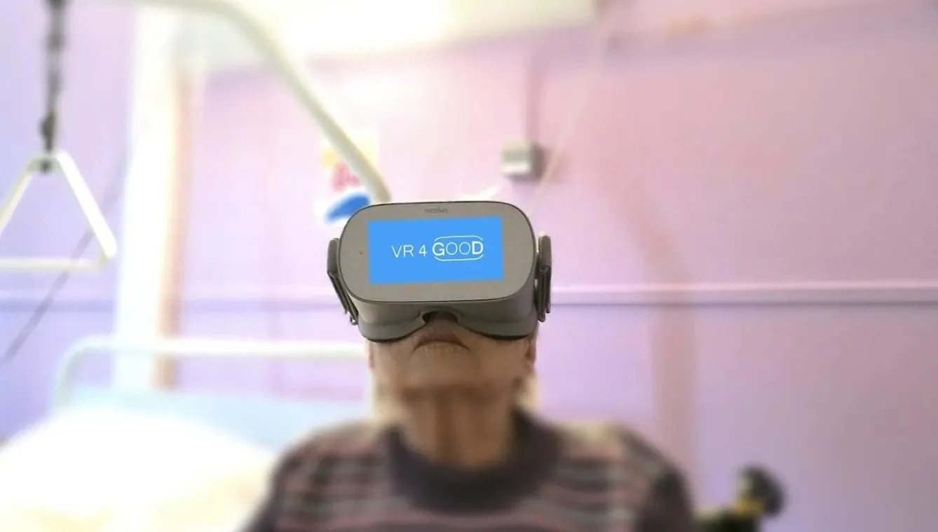 Old woman watching VR in her medical room