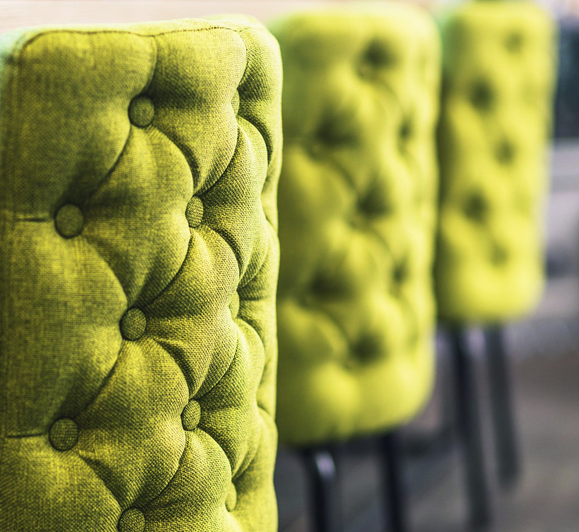 Three green fabric upholstered button back chairs