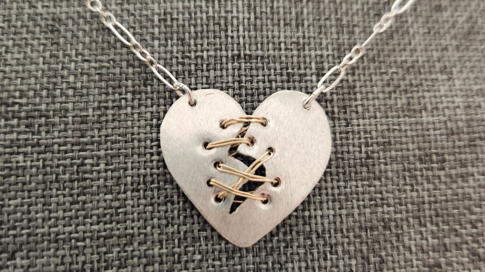 hand-cut sterling silver broken heart, healing heart, pendant 14 karat gold-filled stitches
