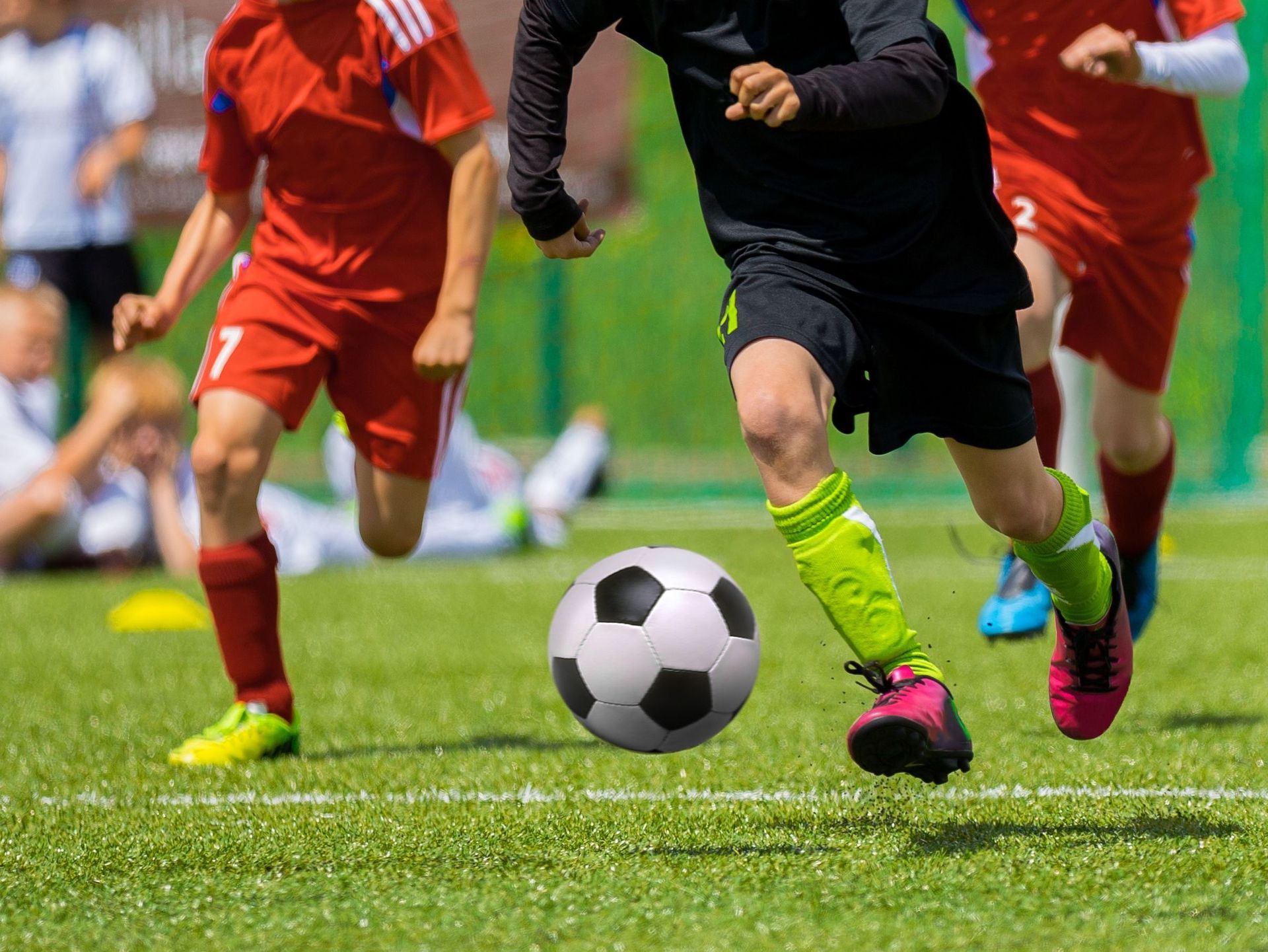 “7–13-year-old football players practicing ball control in MAX Camp”