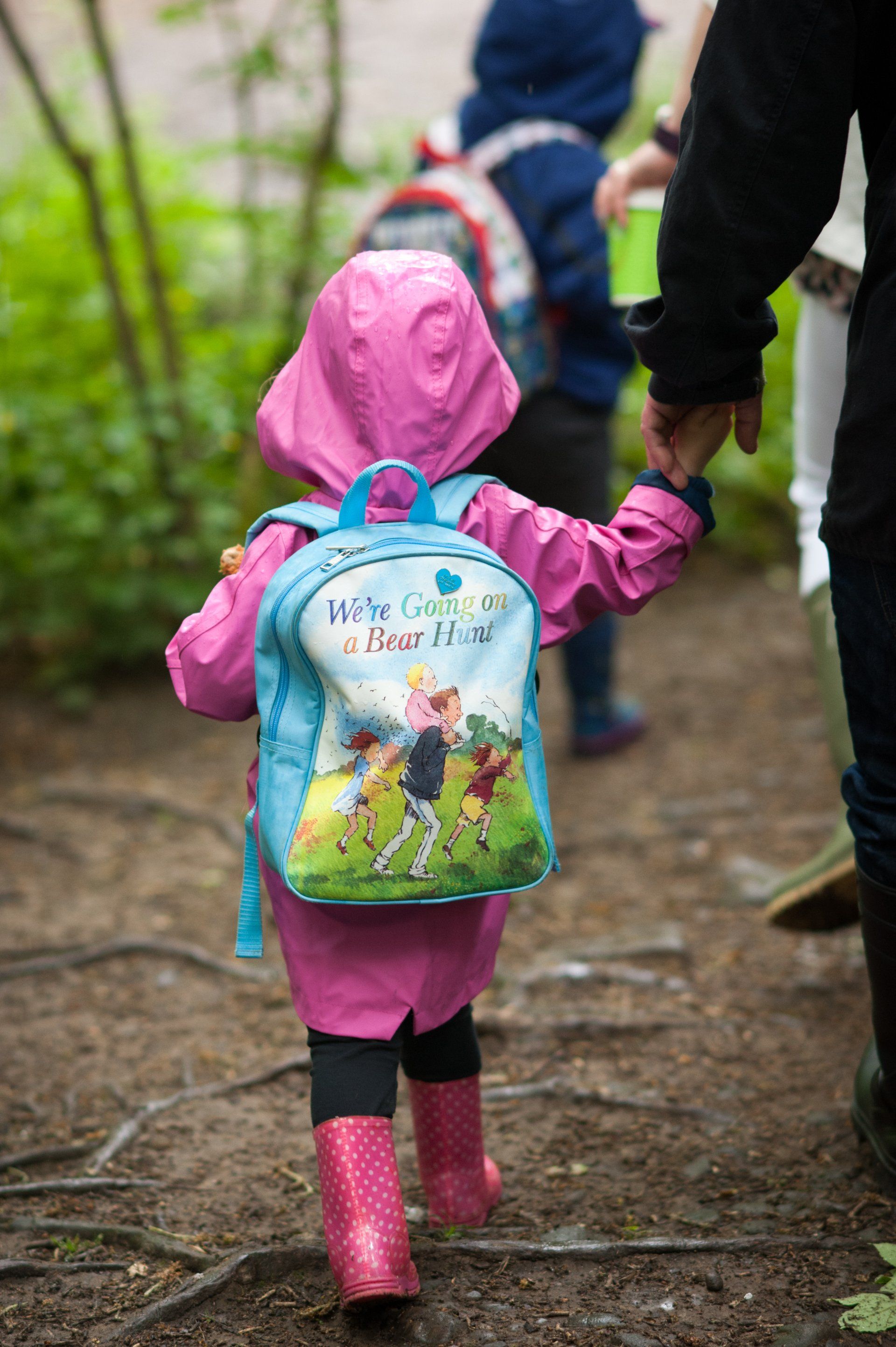A little girl walking in the woods at Nell Bank Outdoor learning centre on the Bear Hunt programme