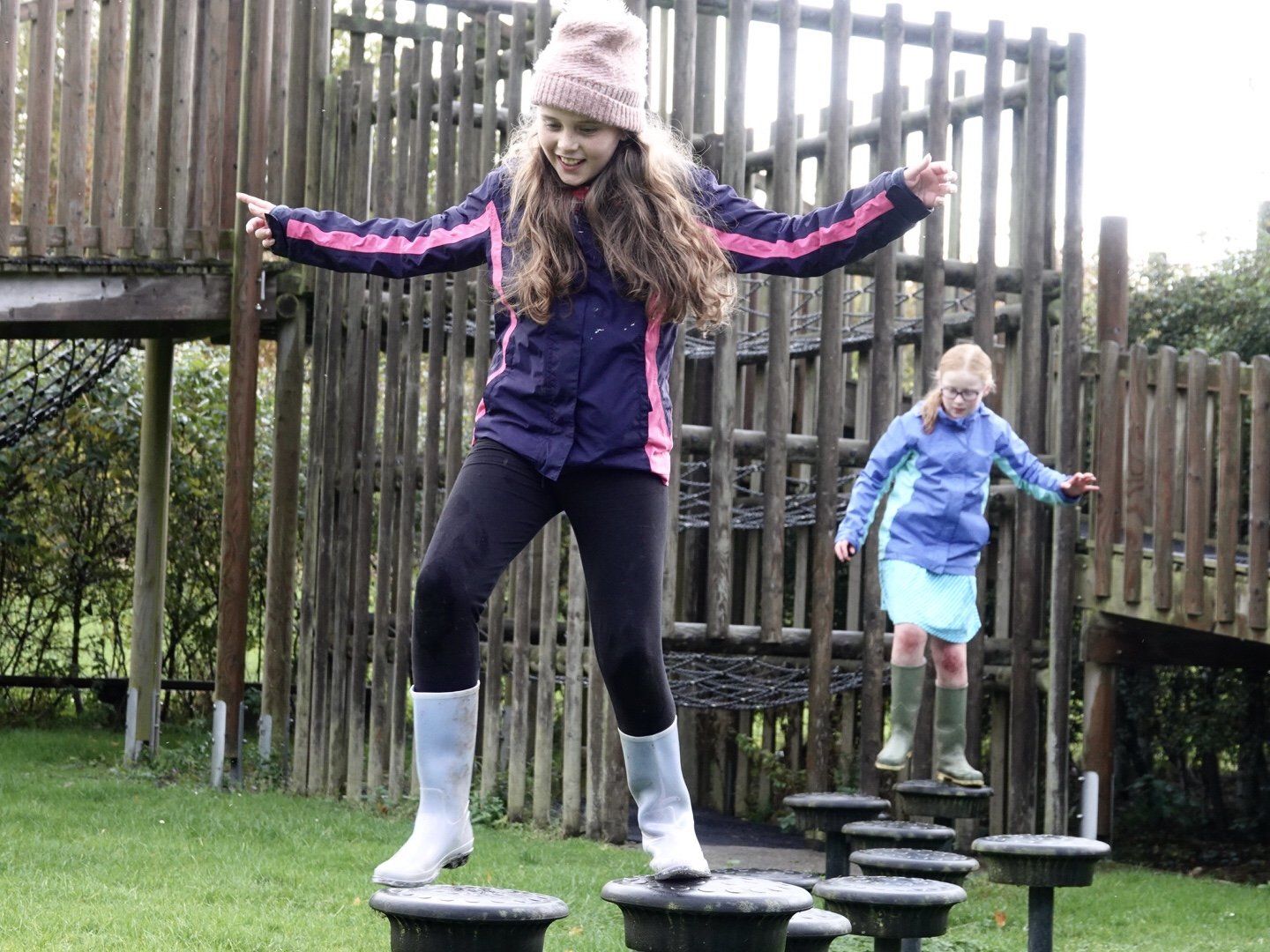 a picture of 2 girls enjoying the assault course at Nell Bank outdoor learning centre