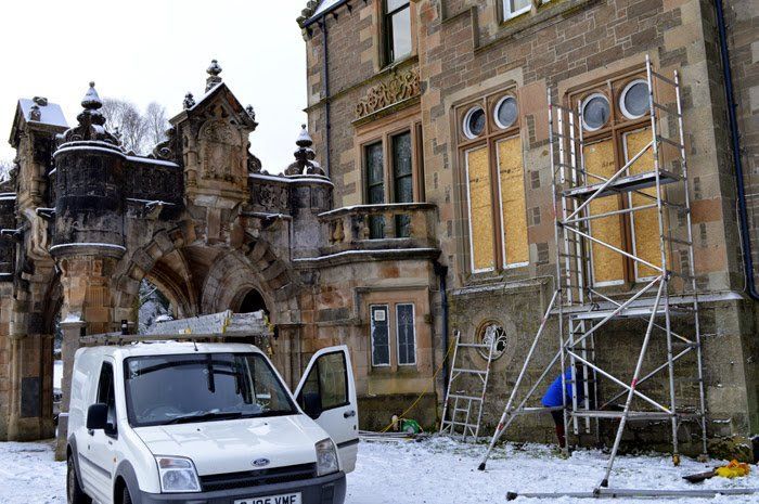 boarding up windows prior to re fitting repaired leaded glass. Auchdennan house. Loch Lomond.