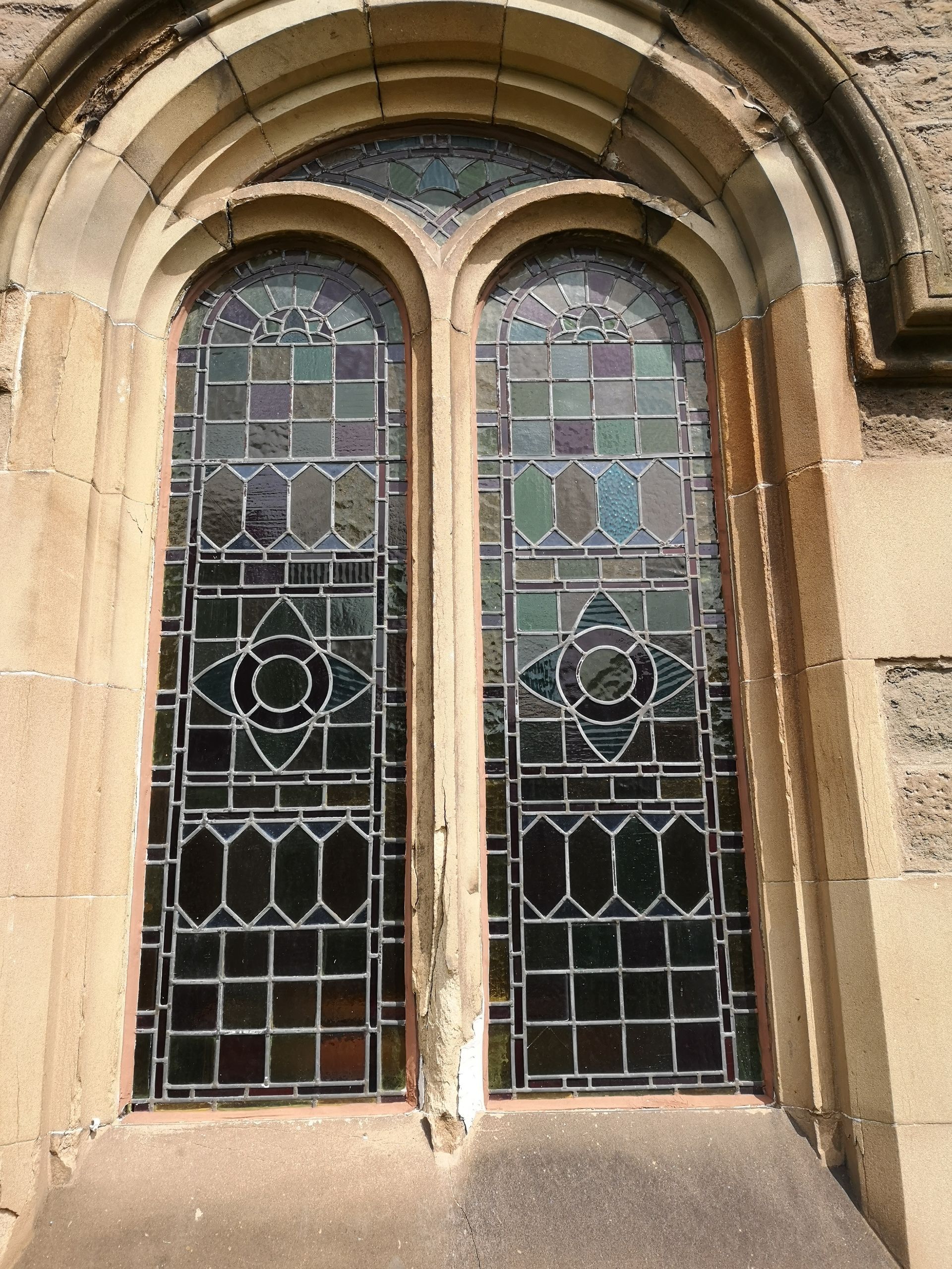 geometirc design stained glass arched window