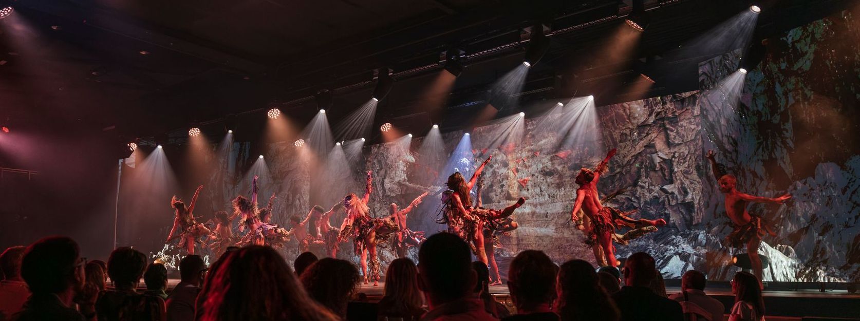 Dancers in tribal costumes performing in Origin, immersive dinner show by Are You Ready