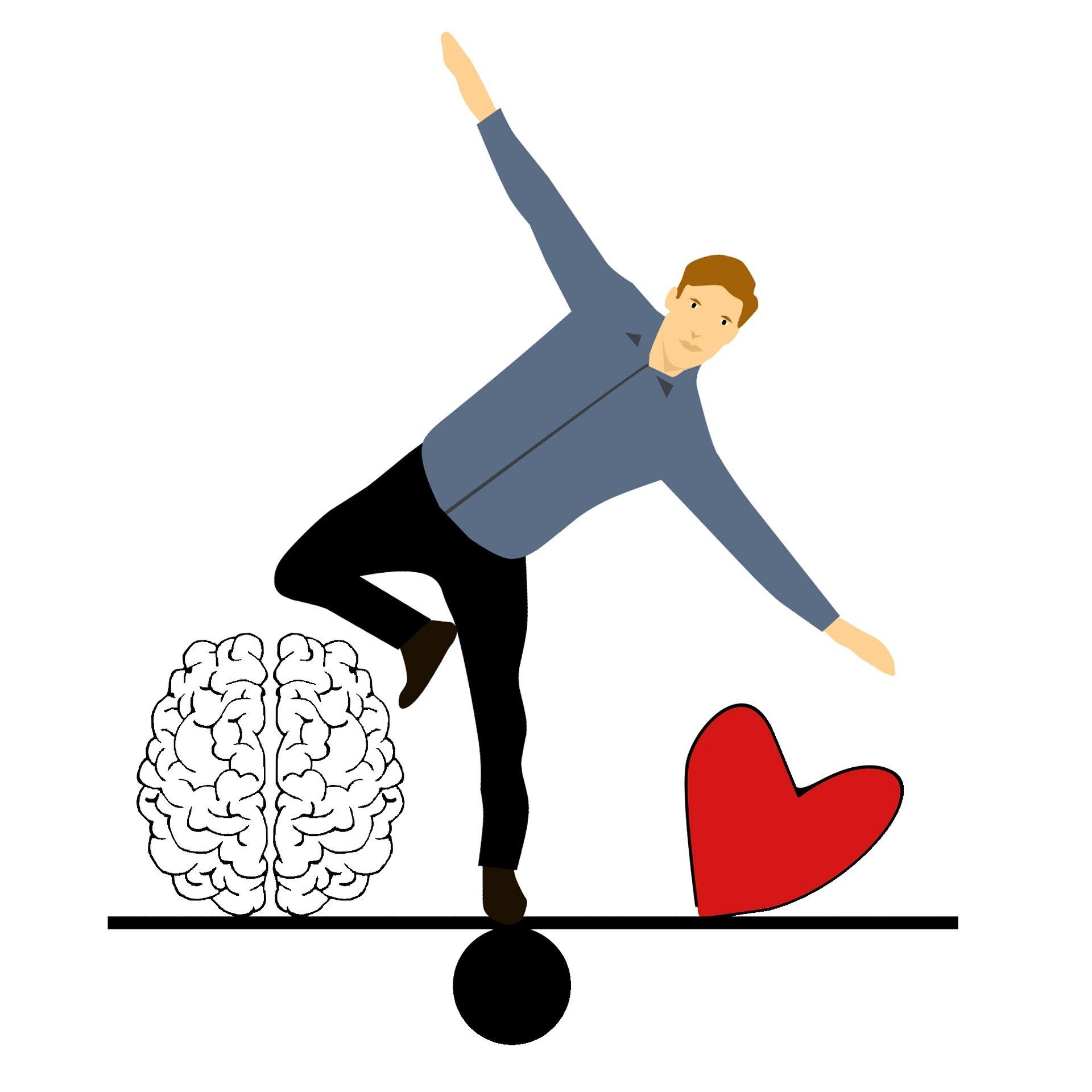 Ein Mann balanciert zwischen Herz und Kopf auf einer Wippe.