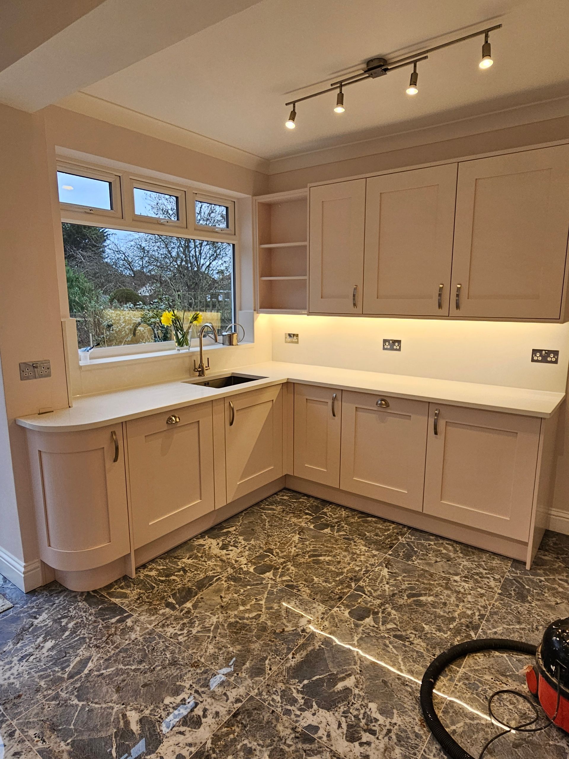 Fitted kitchen in Staines upon Thames with custom cabinets and tiled splashback