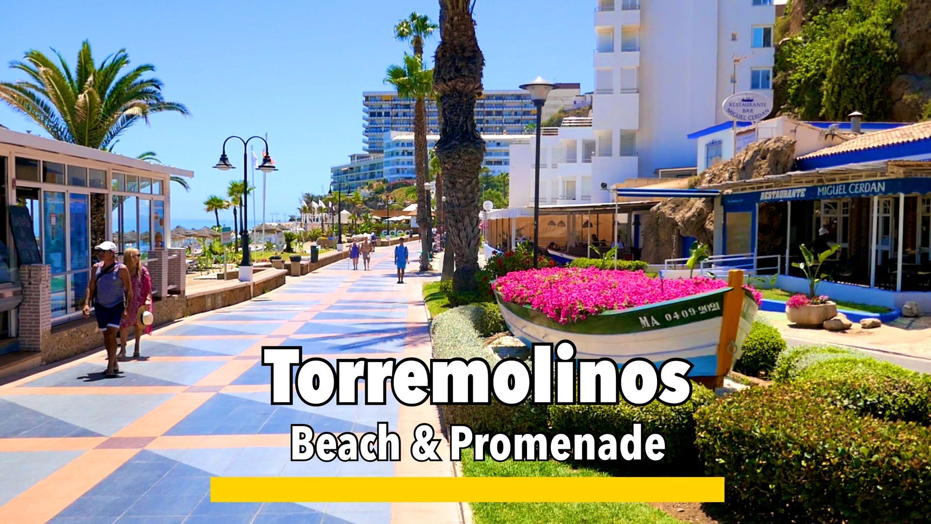 Torremolinos beach and promenade, featuring golden sands, beachfront cafes, and scenic views of the Mediterranean Sea
