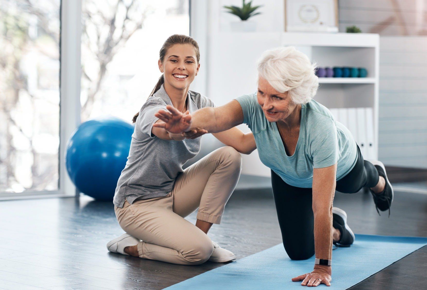 Kinesiologist helping client with core stability