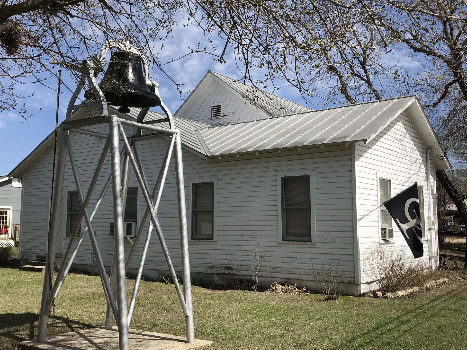 frame frame house with bell in front