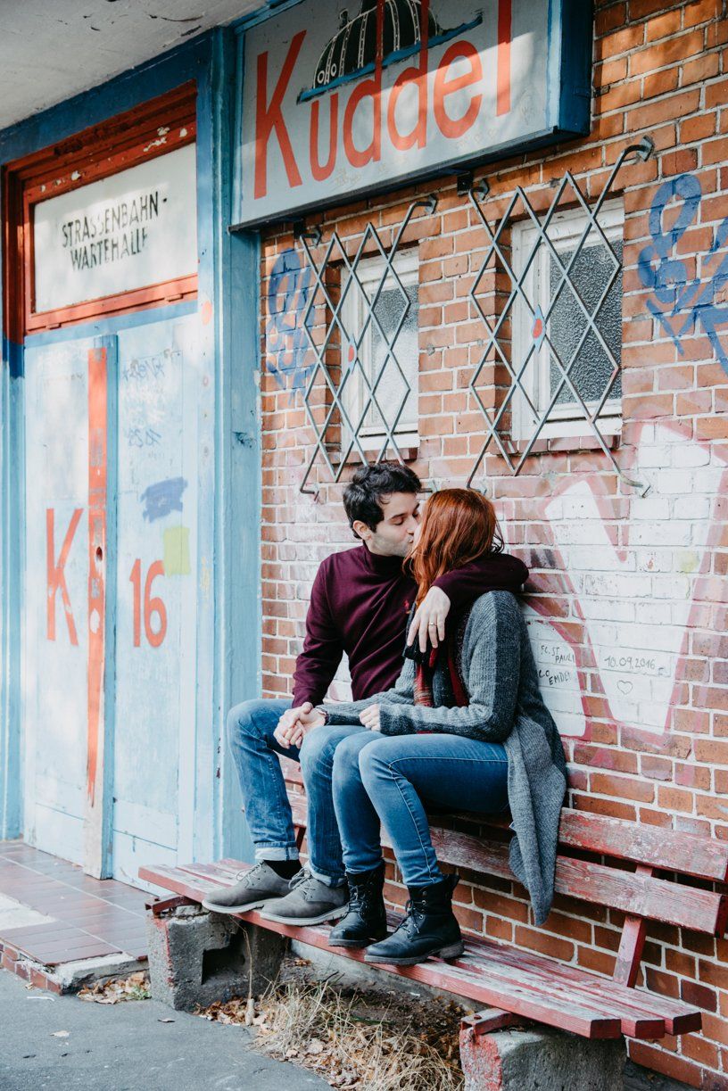 Paarshooting in Kiel, Paar sitzt küssend auf einer Bank vor einer alten Haltestelle