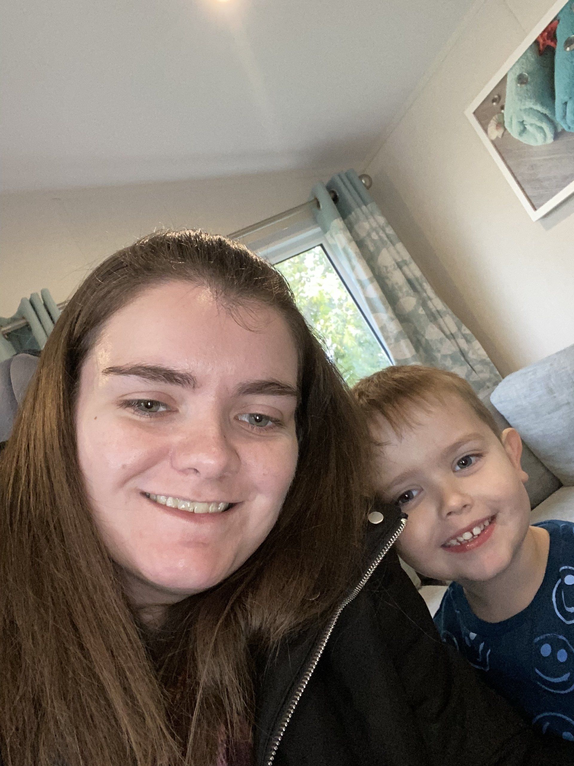 young lady learning in for a picture with a boy child