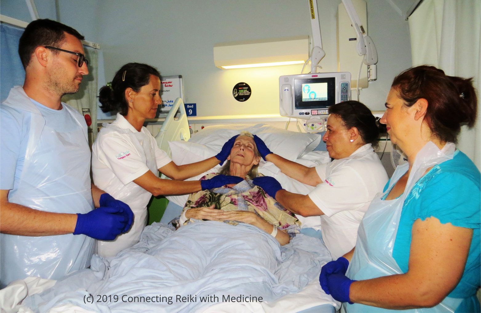 Reiki practitioners giving Reiki to a palliative care patient