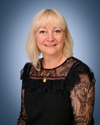 Head and shoulders of a woman with short blonde hair