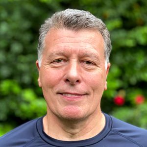 head and shoulders of a man with short hair and a checked shirt