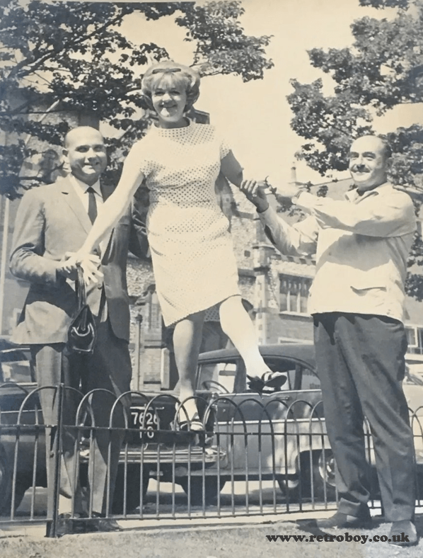Gerald Thomas & Talbot Rothwell give Joan Sims a hand (location unknown, circa 1970).