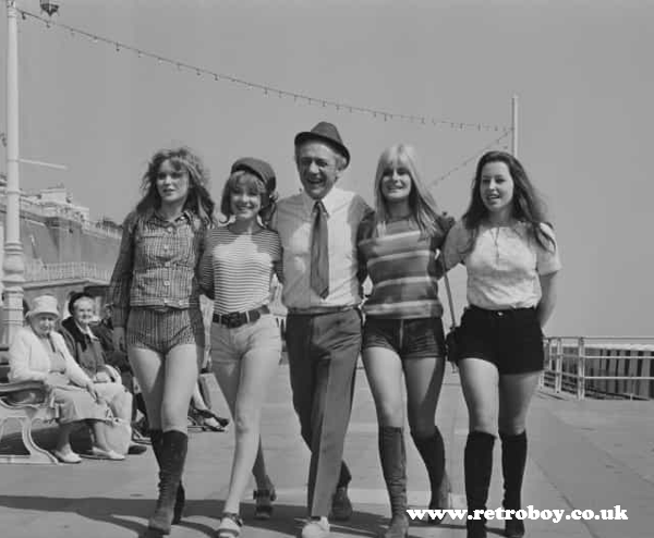 A behind the scenes picture of Sid James with Jacki Piper and the 'Carry On' girls from 'Carry On At Your Convenience' (1971).